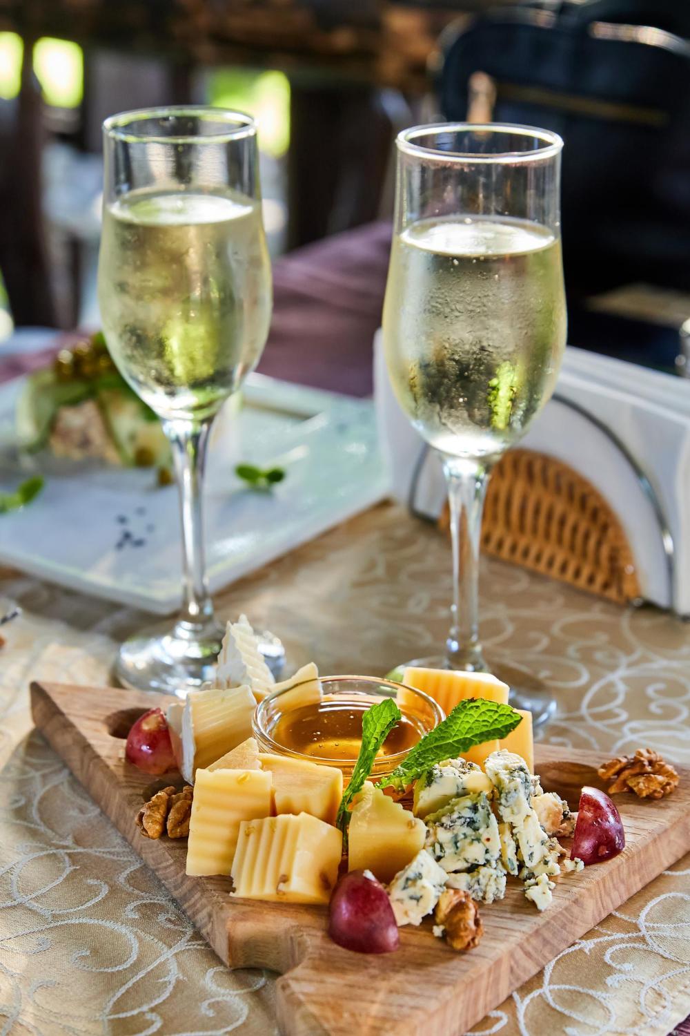 Champagne in glasses next to a cheese board